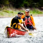 two man enjoying riding canoe