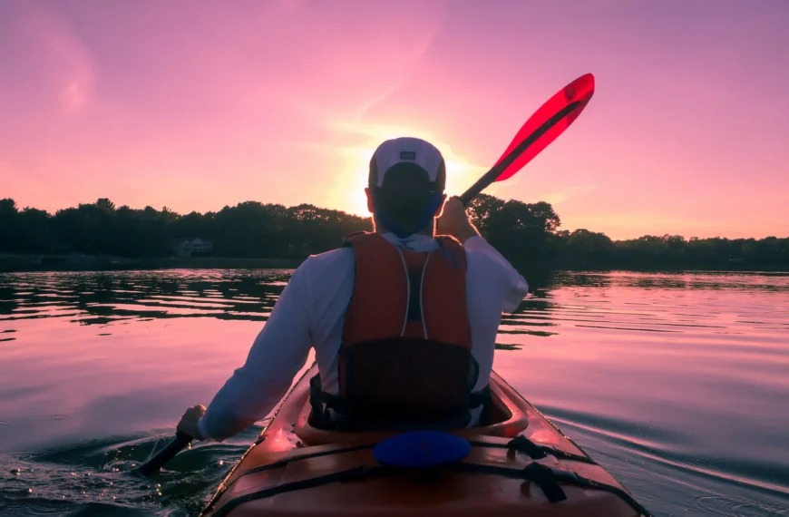 man enjoying kayaking on the evening